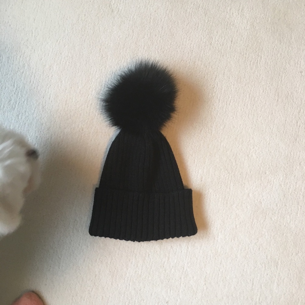 Black hat with a fur puff